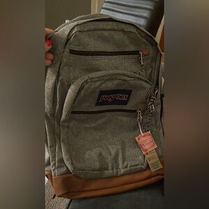 JANSPORT Gray Canvas Backpack with faux leather brown bottom.
